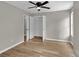 Neutral bedroom with an open closet, ceiling fan and wood-look flooring throughout at 583 Whitaker Nw St, Atlanta, GA 30318