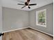 Well-lit bedroom with neutral paint, wood-look floors, ceiling fan, and large window with natural light at 583 Whitaker Nw St, Atlanta, GA 30318