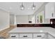 Open kitchen boasts quartz countertops, black backsplash, and stainless steel appliances at 583 Whitaker Nw St, Atlanta, GA 30318