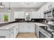Bright kitchen with white cabinets, quartz countertops, stainless steel appliances, and deck access at 583 Whitaker Nw St, Atlanta, GA 30318