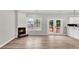 Open living room features a fireplace, hardwood floors, and access to the outdoor deck at 583 Whitaker Nw St, Atlanta, GA 30318