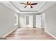 Spacious main bedroom with tray ceiling, ceiling fan, and multiple doorways, perfect for relaxation at 583 Whitaker Nw St, Atlanta, GA 30318