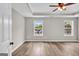 Bright and airy main bedroom with tray ceiling, ceiling fan, and dual windows providing natural light at 583 Whitaker Nw St, Atlanta, GA 30318