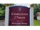 A community sign that reads 'Charleston Pointe, Welcome Home' with a pineapple emblem, set against lush greenery at 2378 Charleston Se Pt, Atlanta, GA 30316
