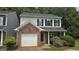 Charming two-story home featuring a brick facade, attached garage, and a well-maintained front yard with lush landscaping at 2378 Charleston Se Pt, Atlanta, GA 30316