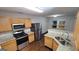 Kitchen featuring stainless steel appliances, granite countertops, wood cabinetry, and window at 2378 Charleston Se Pt, Atlanta, GA 30316