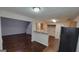 Open-concept layout connecting the kitchen, dining area, and living room, featuring hardwood floors and a cozy atmosphere at 2378 Charleston Se Pt, Atlanta, GA 30316