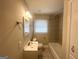 Well-lit bathroom features a shower over tub, window, and vanity with a sink at 3153 Bellgreen Way, Decatur, GA 30032