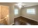 Bedroom with a ceiling fan and hardwood floors. Attached bathroom with marble-tiled shower at 3153 Bellgreen Way, Decatur, GA 30032