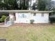 Exterior view of a single-story home with white painted brick and a covered carport at 3153 Bellgreen Way, Decatur, GA 30032
