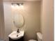 Cozy bathroom featuring a modern vanity with oval mirror, decorative lighting, and a standard toilet at 2327 Scotty Cir, Decatur, GA 30032