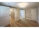 Spacious primary bedroom with wood-look flooring, a barn door closet and a modern light fixture at 2327 Scotty Cir, Decatur, GA 30032