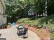 Lush backyard with patio, seating area, and a charming treehouse at 220 Lavender Oasis, Peachtree City, GA 30269