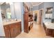 Bright bathroom featuring tub, vanity, storage shelving, and access to the walk-in closet at 220 Lavender Oasis, Peachtree City, GA 30269