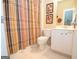 Clean bathroom with neutral color scheme, a white vanity, and a shower with a striped curtain at 220 Lavender Oasis, Peachtree City, GA 30269