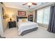 Comfortable bedroom with a queen-sized bed, side table, and a large window with curtains at 220 Lavender Oasis, Peachtree City, GA 30269