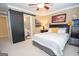 Cozy bedroom with a bed, sliding barn door to the bathroom, and a large window with natural light at 220 Lavender Oasis, Peachtree City, GA 30269