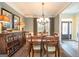 Elegant dining room featuring hardwood floors, stylish decor, and a view into the home's entry way at 220 Lavender Oasis, Peachtree City, GA 30269