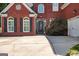 Beautiful brick home with a well-maintained lawn, elegant black shutters, and an attached two-car garage at 220 Lavender Oasis, Peachtree City, GA 30269