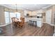 Bright kitchen features white cabinets, stainless steel appliances, and island with seating at 220 Lavender Oasis, Peachtree City, GA 30269