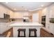 Bright kitchen featuring white cabinets, stainless steel appliances, and a large center island at 220 Lavender Oasis, Peachtree City, GA 30269