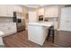 Clean kitchen with white cabinets, stainless appliances, and a marble countertop island at 220 Lavender Oasis, Peachtree City, GA 30269