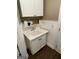Charming laundry room with white cabinets, sink, and wainscoting for added appeal at 220 Lavender Oasis, Peachtree City, GA 30269