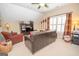 Comfortable living room offers a relaxing atmosphere with a ceiling fan and natural light from a window at 220 Lavender Oasis, Peachtree City, GA 30269