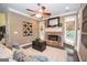 Comfortable living room with stone fireplace, neutral color palette, and plenty of natural light at 220 Lavender Oasis, Peachtree City, GA 30269
