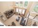 Spacious living room with soaring ceilings, large windows, and comfortable seating at 220 Lavender Oasis, Peachtree City, GA 30269