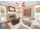 Comfortable living room with fireplace, large windows, and stylish accents at 220 Lavender Oasis, Peachtree City, GA 30269