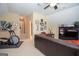 Spacious living room featuring a large entertainment center, comfortable seating, and an exercise machine at 220 Lavender Oasis, Peachtree City, GA 30269