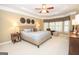 Spacious bedroom features a tray ceiling, ceiling fan, many windows, and neutral decor at 220 Lavender Oasis, Peachtree City, GA 30269
