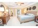 Spacious main bedroom with tray ceiling, large bed, and ensuite bathroom access at 220 Lavender Oasis, Peachtree City, GA 30269