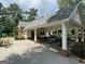 A covered patio area with picnic tables near the pool, perfect for gatherings and relaxation at 220 Lavender Oasis, Peachtree City, GA 30269