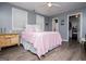 Charming bedroom featuring grey walls, wood floors, and a cozy pink quilt at 6391 Katherine St, Douglasville, GA 30134