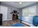 Well-lit bedroom with a study area, blue rug, and comfortable bed at 6391 Katherine St, Douglasville, GA 30134