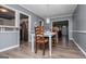 Charming dining area with white table, chairs, and seamless transition to the kitchen at 6391 Katherine St, Douglasville, GA 30134