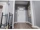 Hallway leading to the front door featuring wood-look floors and trim, with a bench at 6391 Katherine St, Douglasville, GA 30134