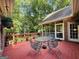 Inviting back deck with a glass table and surrounding natural views at 280 Emerald Lake Dr, Fayetteville, GA 30215