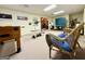 Finished basement with a weight bench, foosball table, ping pong table, and wicker chairs for entertainment at 280 Emerald Lake Dr, Fayetteville, GA 30215