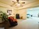 Finished basement with a comfortable red chair, TV area, and a ping pong table visible in the background at 280 Emerald Lake Dr, Fayetteville, GA 30215