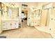 Bathroom showcasing dual vanities, mirrors, and a glass-enclosed shower for convenience at 280 Emerald Lake Dr, Fayetteville, GA 30215