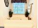 Relaxing bathtub situated beneath a window, surrounded by decorative plants and candles at 280 Emerald Lake Dr, Fayetteville, GA 30215