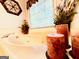 Relaxing bathtub situated beneath a window, surrounded by decorative plants and candles at 280 Emerald Lake Dr, Fayetteville, GA 30215