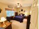 Cozy bedroom featuring a ceiling fan, desk, and natural light, perfect for relaxation at 280 Emerald Lake Dr, Fayetteville, GA 30215