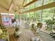 Expansive screened porch with wood flooring and multiple seating areas at 280 Emerald Lake Dr, Fayetteville, GA 30215