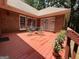 Cozy brick patio with a table, chairs, and potted plants, perfect for outdoor dining and relaxation at 280 Emerald Lake Dr, Fayetteville, GA 30215