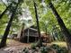 Exterior view of the property with a screened porch, red deck, and wooded surroundings providing privacy at 280 Emerald Lake Dr, Fayetteville, GA 30215