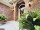 Welcoming front entrance with brick surround, decorative wreath, and manicured ferns at 280 Emerald Lake Dr, Fayetteville, GA 30215